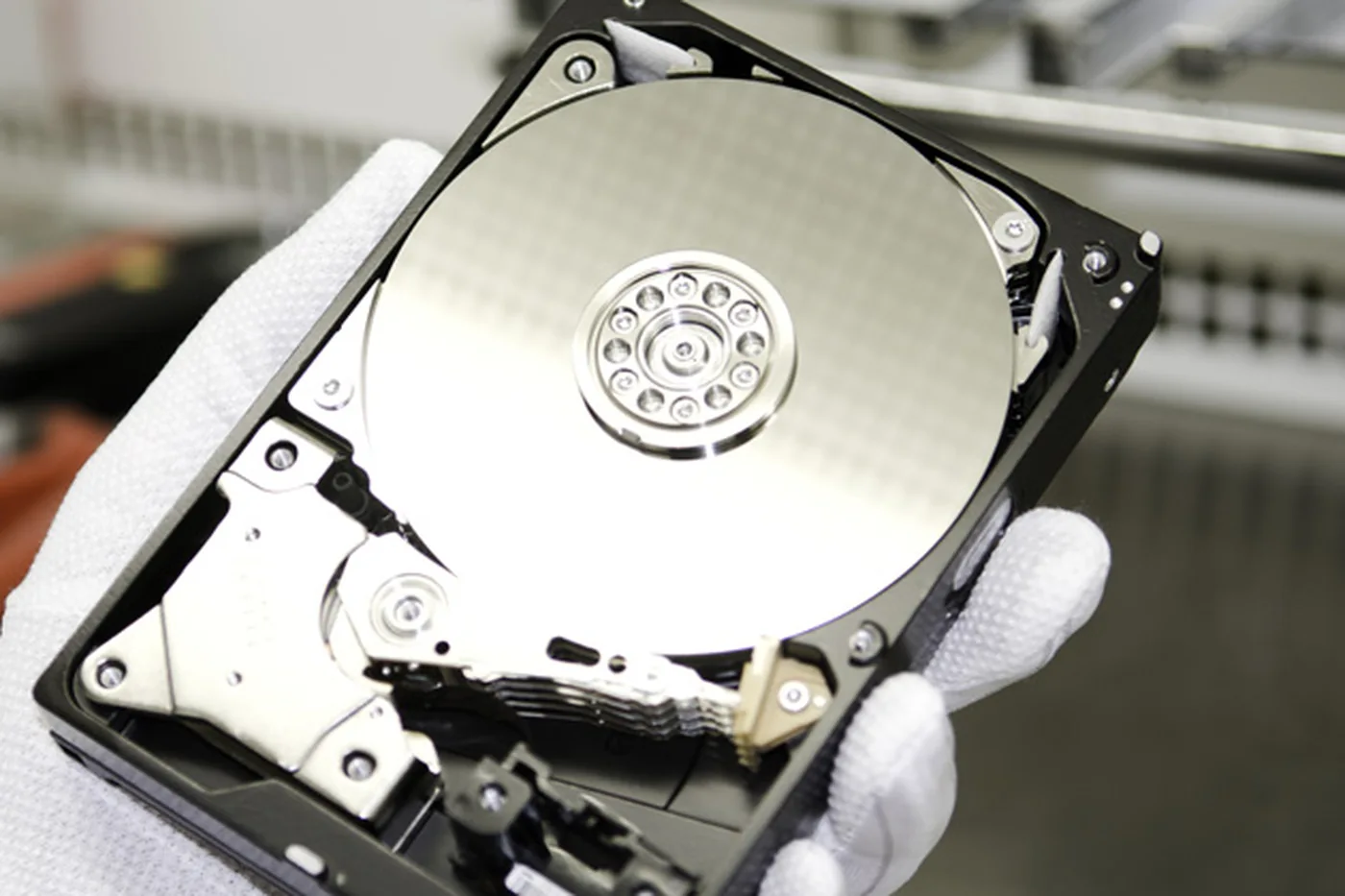 Hard drive held in the hand, prepared for examination in the lab