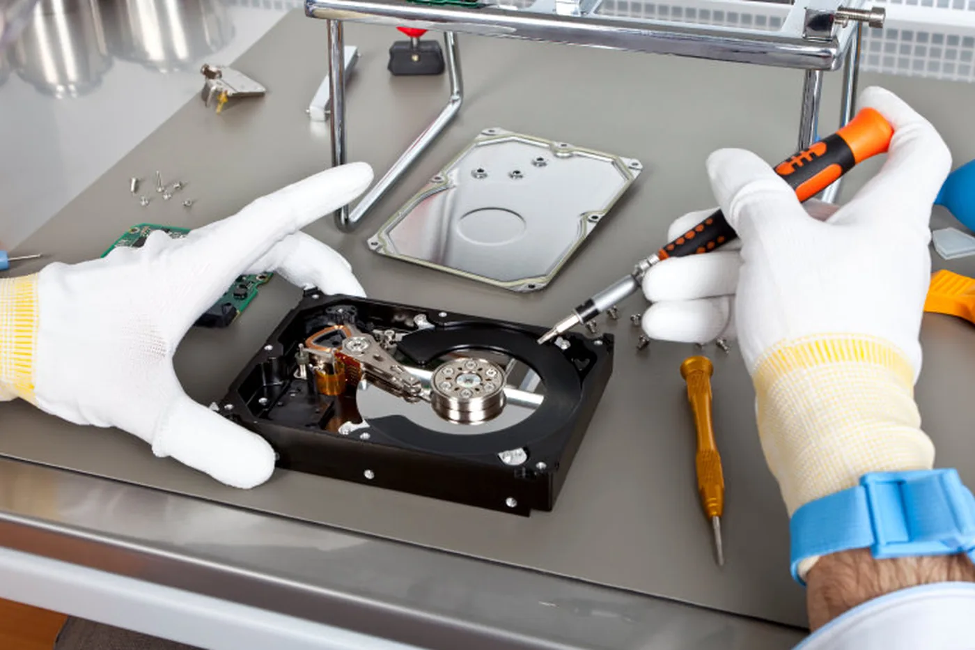 Technician examining a removed storage medium at the bench